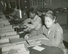 Members of the Women's Army Corps identifying incorrectly addressed mail for soldiers..., 1943. Creator: Unknown