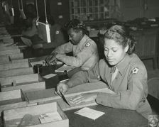Members of the Women's Army Corps identifying incorrectly addressed mail for soldiers..., 1943. Creator: Unknown