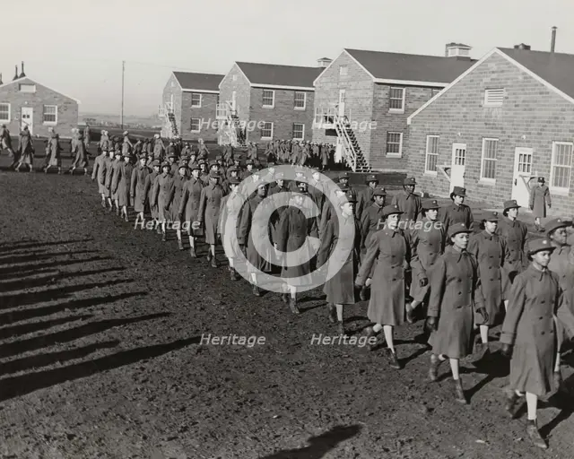 Members of an all-African American company walking in rows during an infantry drill..., 1943. Creator: Unknown.