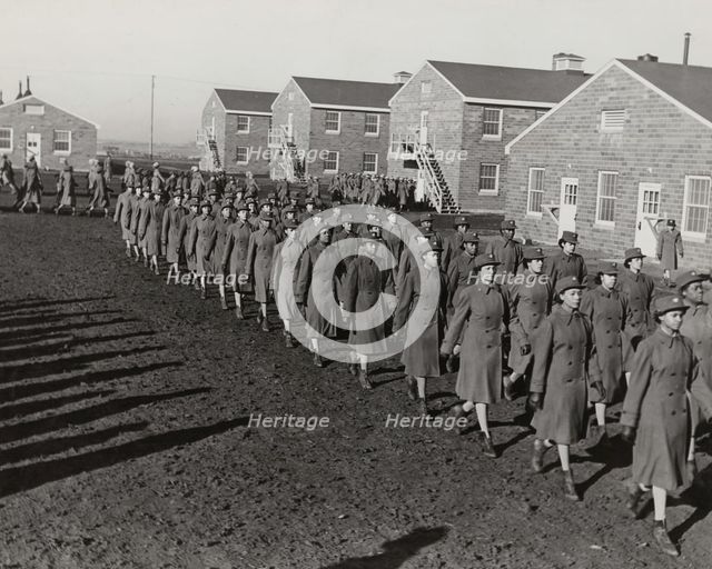 Members of an all-African American company walking in rows during an infantry drill..., 1943. Creator: Unknown.