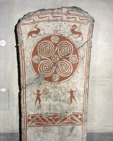 Memorial picture stone decorated with whorls symbolising the sun and vignettes from the hunt