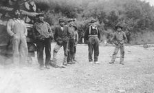 Men next to logs, between c1900 and 1916. Creator: Unknown