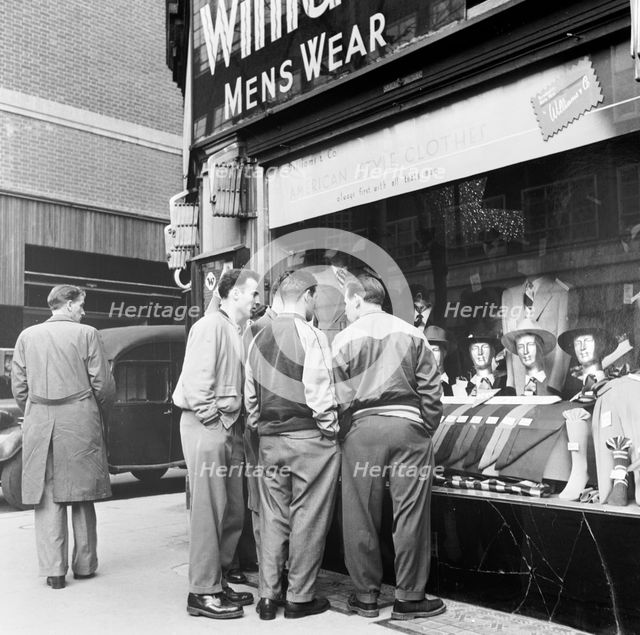 Men outside a menswear shop, London, late 1950s. Creator: Henry Grant.