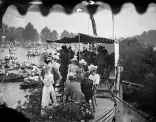Men and women take tea on a college barge overlooking the Henley Royal Regatta, Oxfordshire, 1897. Creator: Henry Taunt