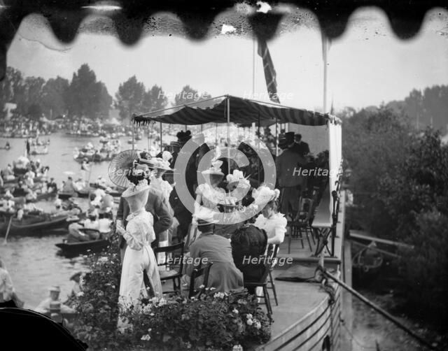 Men and women take tea on a college barge overlooking the Henley Royal Regatta, Oxfordshire, 1897. Creator: Henry Taunt.