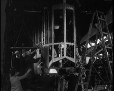Men and Women Building the Body of the Cockpit of an R 38 Airship in a Hangar, 1921. Creator: British Pathe Ltd