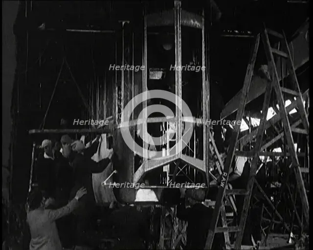 Men and Women Building the Body of the Cockpit of an R 38 Airship in a Hangar, 1921. Creator: British Pathe Ltd.