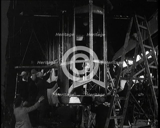 Men and Women Building the Body of the Cockpit of an R 38 Airship in a Hangar, 1921. Creator: British Pathe Ltd.