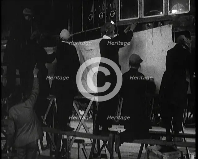 Men and Women Building the Body of the Cockpit of an R 38 Airship in a Hangar, 1921. Creator: British Pathe Ltd.