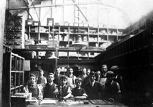 Men and boys in a printing workshop, (late 19th-early 20th century?). Creator: Unknown