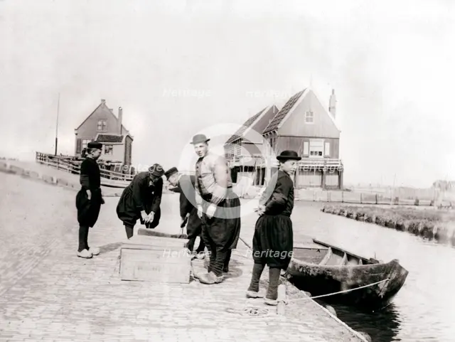 Men and boys in traditional costume by a canal bank, Marken Island, Netherlands, 1898. Artist: James Batkin
