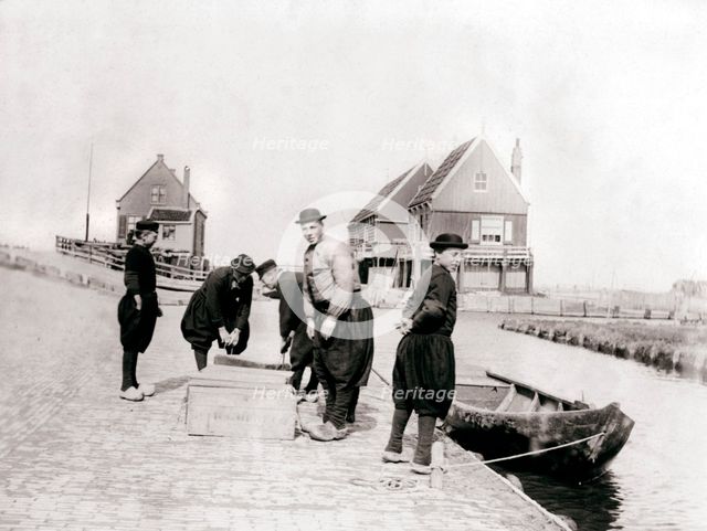 Men and boys in traditional costume by a canal bank, Marken Island, Netherlands, 1898. Artist: James Batkin