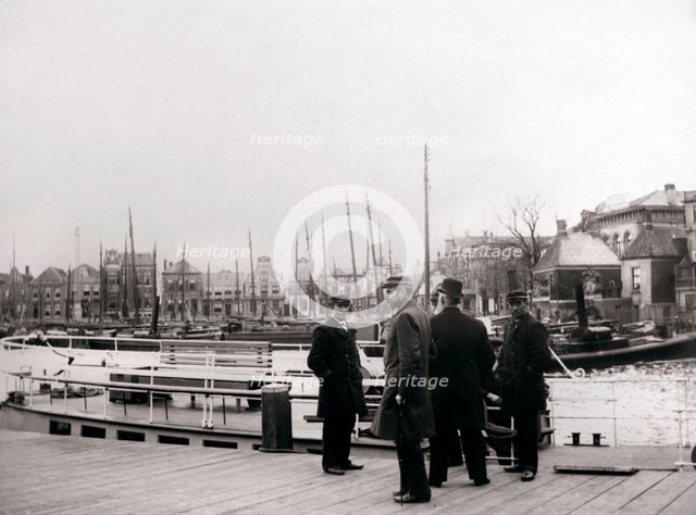 Men by a canal boat, Rotterdam, 1898.Artist: James Batkin