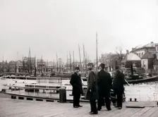 Men by a canal boat, Rotterdam, 1898.Artist: James Batkin