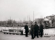 Men by a canal boat, Rotterdam, 1898.Artist: James Batkin