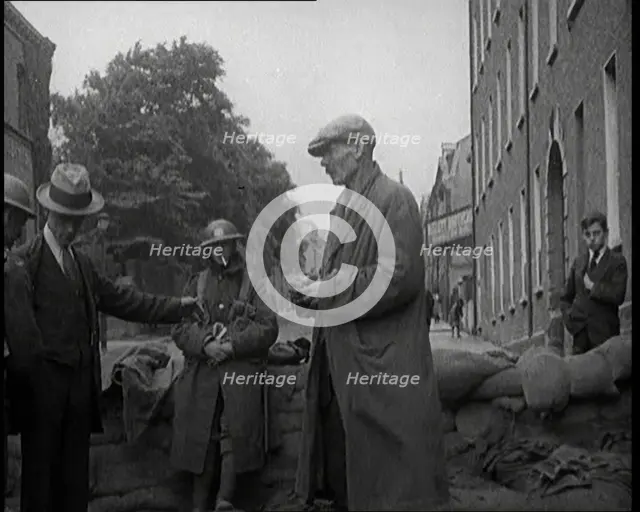 Men Being Stopped and Searched at a Roadblock in Ireland, United Kingdom, 1920. Creator: British Pathe Ltd.