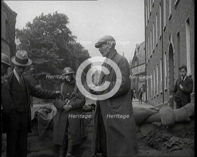 Men Being Stopped and Searched at a Roadblock in Ireland, United Kingdom, 1920. Creator: British Pathe Ltd.