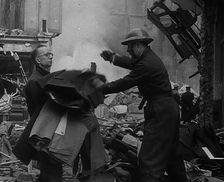 Men Clearing Out Possessions from a Bombed Out Building, 1940. Creator: British Pathe Ltd
