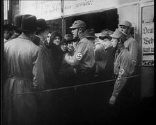 Men in Nazi Uniforms and Civilians Standing Outside a Shop With anti-Jewish Posters on it, 1933. Creator: British Pathe Ltd
