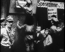 Men in Nazi Uniforms attaching anti-Jewish Posters, 1933. Creator: British Pathe Ltd