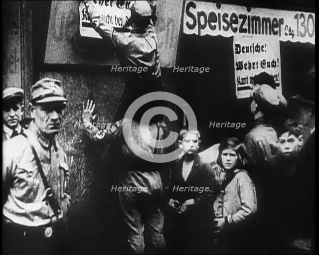 Men in Nazi Uniforms attaching anti-Jewish Posters, 1933. Creator: British Pathe Ltd.