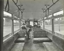 Men in hats and coats in the interior of an electric tram, London, 1933