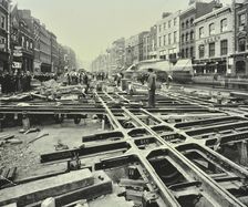 Men laying tramlines at a junction, Whitechapel High Street, London, 1929