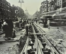 Men laying tramlines in the middle of the road, Whitechapel High Street, London, 1929