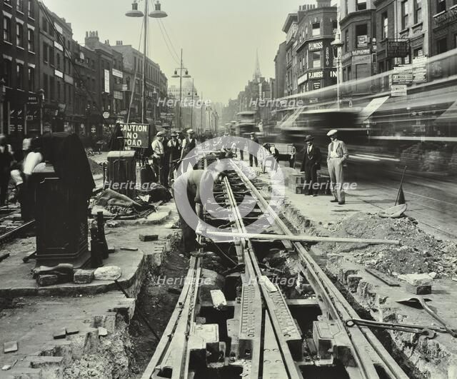 Men laying tramlines in the middle of the road, Whitechapel High Street, London, 1929. Artist: Unknown.