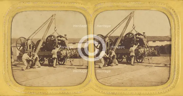 Men loading large iron wheels on platform, about 1865. Creator: Unknown.