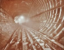 Men pushing railway trucks along the Rotherhithe Tunnel, Stepney, London, June 1907