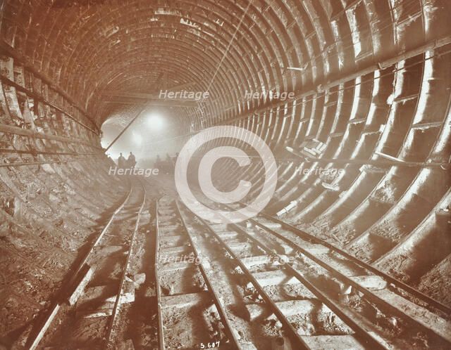 Men pushing railway trucks along the Rotherhithe Tunnel, Stepney, London, June 1907. Artist: Unknown.