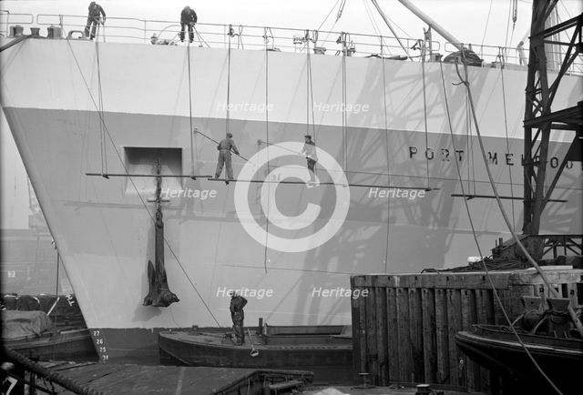 Men painting a vessel, Tilbury, Essex, c1945-c1965. Artist: SW Rawlings