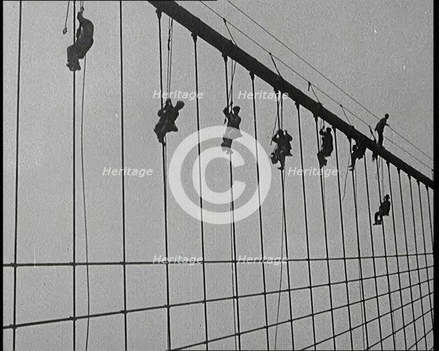 Men Painting the Brooklyn Bridge in New York City, 1922. Creator: British Pathe Ltd.