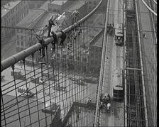 Men Painting the Brooklyn Bridge in New York City, 1922. Creator: British Pathe Ltd