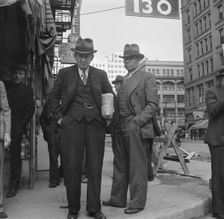 Men pause a moment to watch, and then pass on, Salvation Army, San Francisco, California, 1939. Creator: Dorothea Lange