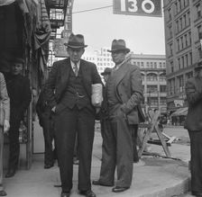 Men pause a moment to watch, and then pass on, Salvation Army, San Francisco, California, 1939. Creator: Dorothea Lange