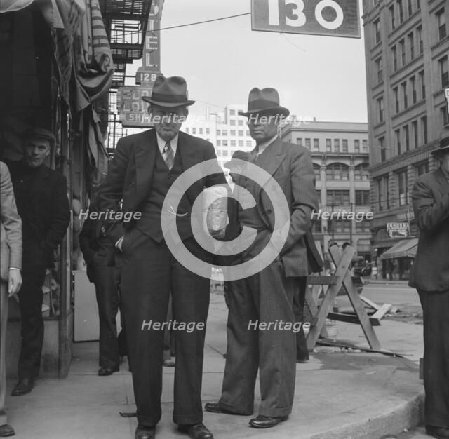 Men pause a moment to watch, and then pass on, Salvation Army, San Francisco, California, 1939. Creator: Dorothea Lange.