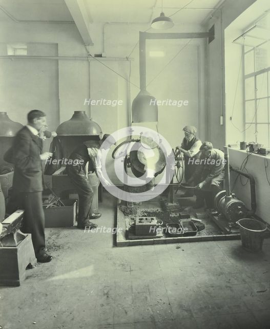 Men pouring molten metal in a foundry, School of Engineering and Navigation, London, 1931. Artist: Unknown.