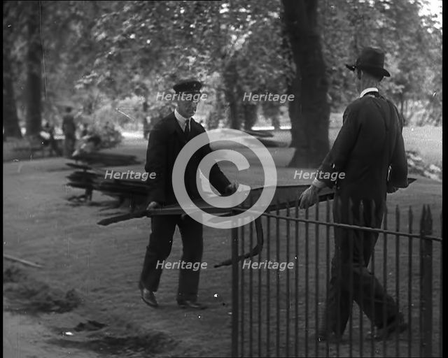 Men Removing Park Railings for Use in Factories, 1940. Creator: British Pathe Ltd.