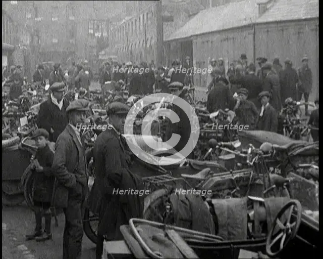 Men Standing Around Groups of Motorcars and Motorbikes, 1920. Creator: British Pathe Ltd.