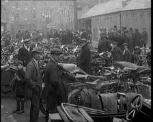 Men Standing Around Groups of Motorcars and Motorbikes, 1920. Creator: British Pathe Ltd