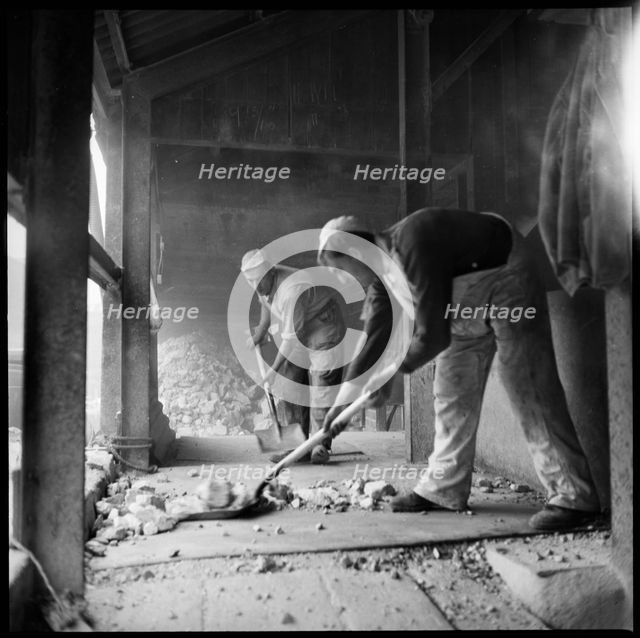 Men shovelling flint in a flint calcinating kiln, WJ Dolby works, Stoke-on-Trent, 1965-1968. Creator: Eileen Deste.