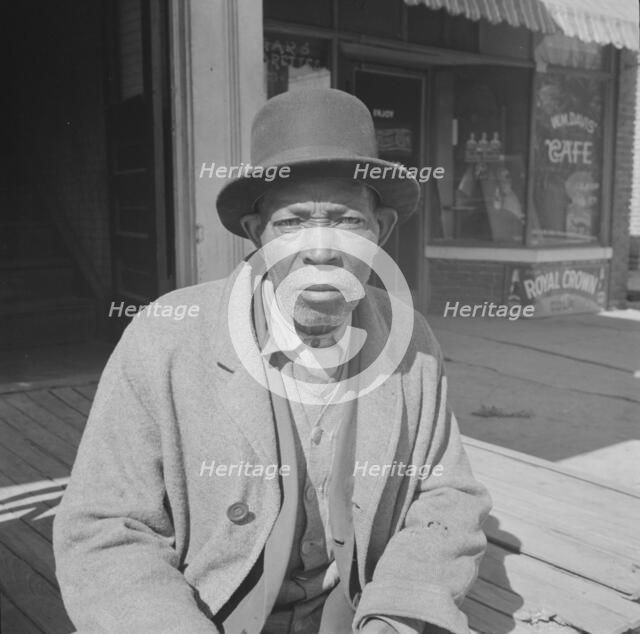 Men sitting in the sun on Sunday morning, Daytona Beach, Florida, 1943. Creator: Gordon Parks.