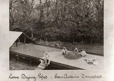 Men spreading out cocoa beans in Cocoa Drying Sheds, Trinidad, San Antonio, 1897