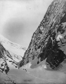Men traveling with horses through snow covered valley, between c1900 and c1930. Creator: Unknown