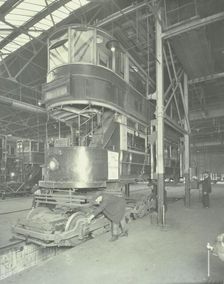 Men using a car lifting hoist at Charlton Central Repair Depot, London, 1932