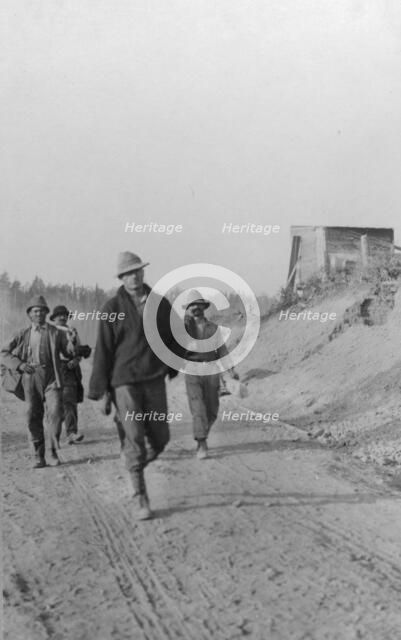Men walking on dirt road, between c1900 and 1916. Creator: Unknown.