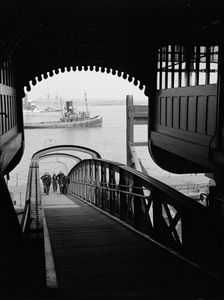 Men walking up a wooden bridge on a river, c1945-c1965. Artist: SW Rawlings