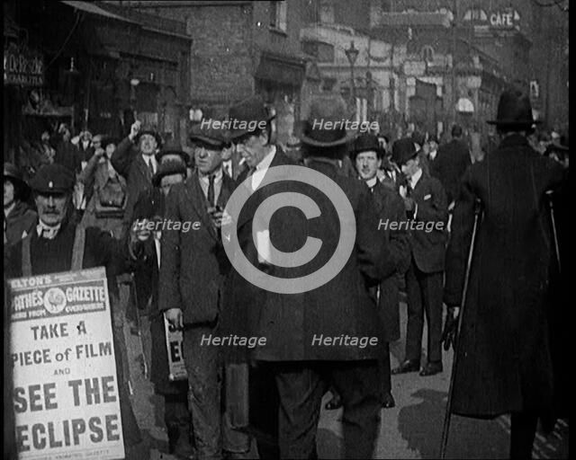 Men Wearing 'Pathe Gazette' Sandwich Boards Handing Out Pieces of Polaroid Film to Crowds..., 1921. Creator: British Pathe Ltd.